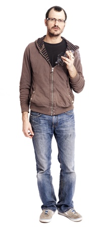 An adult caucasian man at his early 30's wearing casual sneakers, a pair of blue jeans and a hoodie over a black t-shirt, and holding a rolled cigarette/joint in his hand. He's looking at the camera with a serious gaze, as if in the middle of speaking. Isの写真素材