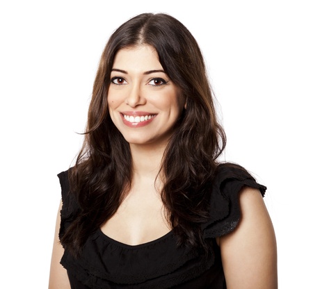 Beautiful young adult Caucasian woman in her mid 20's looking at the camera with a large toothy smile on her face. Isolated on white background.の写真素材