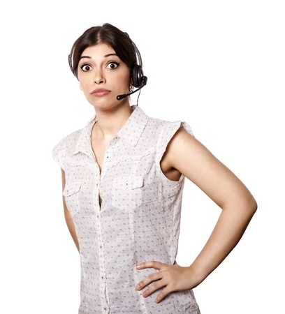 A bautiful young adult Caucasian woman wearing a headset and giving the camera a surprised gaze  Wonder what sheの写真素材