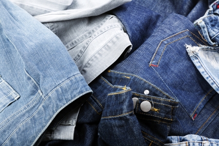 Various pairs of jeans pants scattered in chaos.