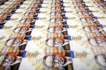A high angle view of a very large amount of 100 NIS (New Israeli Shekel) money notes.