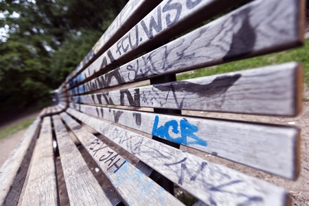 Wide angle view of a grafitti covered bench at Gorlitzer park, Berlin, Germany.の写真素材