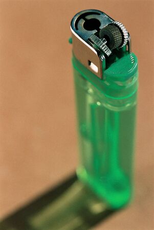 Malfunctioning green used lighter high angle view.の写真素材