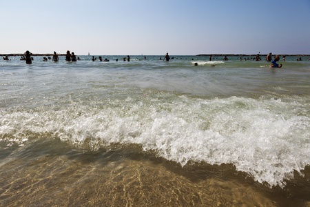 Tel-Aviv, Israel - Augutst 18th, 2012: The Tel-Aviv beach a clear summer day; packed with many people bathing in the water.のeditorial素材