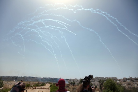 Bil'in, Palestine - May 17th, 2013: Tear gas canniesters mid-air on the way to the Palestinian protest taking place by the separation wall, above the protesters.のeditorial素材