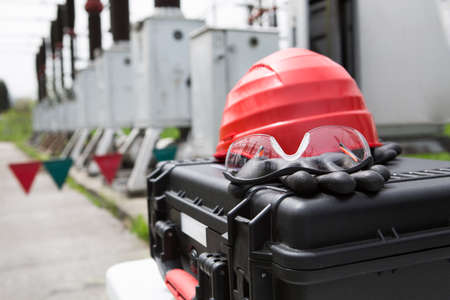 Hard hat,safety glasses and gloves on tool box.Safety gear kit close up,safety equipment for work...