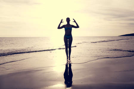 Vacation vitality healthy living concept.Woman practicing yoga and meditating.Serene woman in pure happiness and enjoymentの写真素材