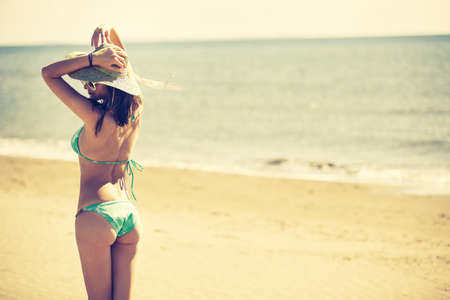 Summer beach fashion woman enjoying summer and sun.Concept of summer feeling,happiness.Fit and healthy summer body.Relaxed woman breathing fresh air,emotional sensual woman.Travel and vacationの写真素材