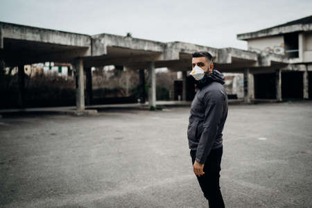 Scared worried man wearing a protective mask.Activities in time of epidemic/pandemic.Panic and fear of infection.Life in contaminated area.Actions for prevention and control.Nosophobiaの写真素材
