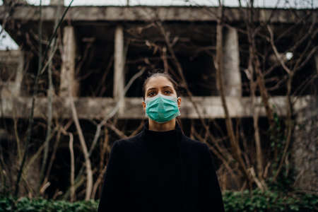 Patient suffering from infectious disease,sick person in mask.Scared woman suffering from symptoms of incurable infectious disease.Woman with illness.Nosophobiaの写真素材