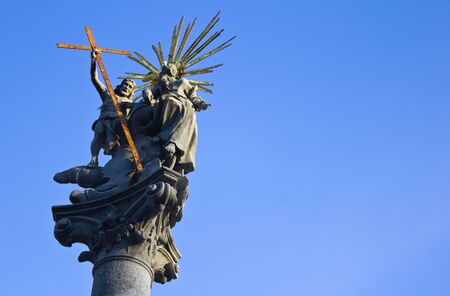 Statue of Christ carrying a cross, in the middle of Bratislava, Slovakia with a perfectly clear blue sky.のeditorial素材