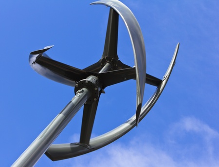 Silent urban styled wind turbine, low angle view, blue sky.の写真素材