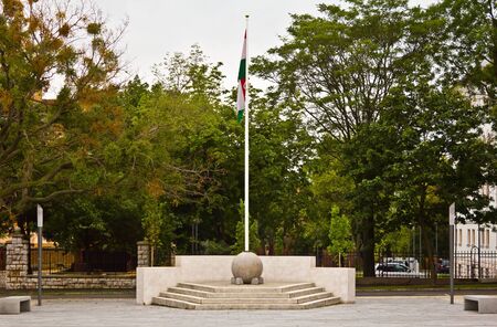 Hungarian flag on a pole in the middle of a park in Pecs, Hungary.の写真素材