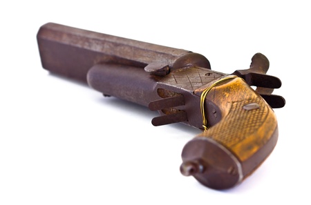 Old black rusty gun, lower side, selective focus, on white background.の写真素材