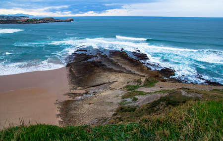 Beach of sand and rocks with a perfectly blue sea.の写真素材