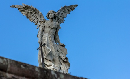 Stone sculpture of an archangel holding a sword の写真素材