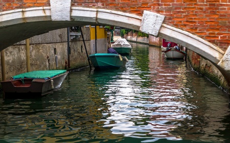 Venice street with several boats behind a brige.の写真素材