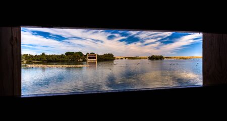 View of the Villafafila lake through an observatory window の写真素材