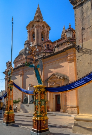 Religious decorations on the street and church dedicated to St Catherine in Zurrieq, Malta の写真素材
