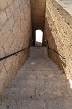 Stairs leading to a door with a blind white light in the streets of the citadel of Gozo, Malta の写真素材