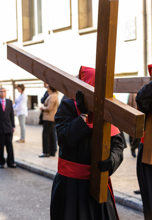 VALLADOLID, SPAIN – APRIL 17, 2014  Nazareno carrying a cross in the religious processions during...