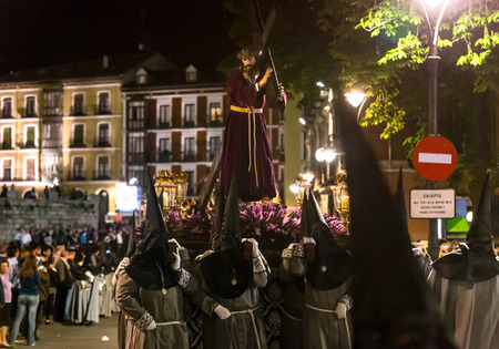 VALLADOLID, SPAIN  APRIL 17, 2014  Nazarenos carrying a Jesuschrist sculpture in the religious processions during Holy Week on Good Thursday Night, on April 17, 2014 in Valladolid, Spain のeditorial素材