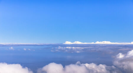 Fog bank between blue sky and ocean の写真素材