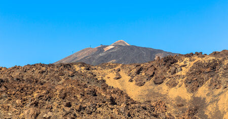 Teide volcano beyond volcanic rocks in Tenerife の写真素材