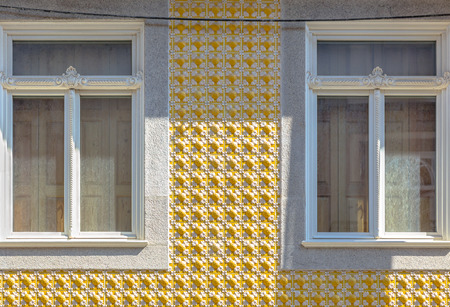 Yellow tile decoration in a Porto building.の写真素材