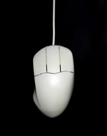 Computer white mouse over a black backgroundの写真素材
