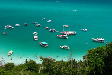 Boats over a crystalline turquoise sea in Arraial do Cabo, Rio de janeiro, Brazilの写真素材