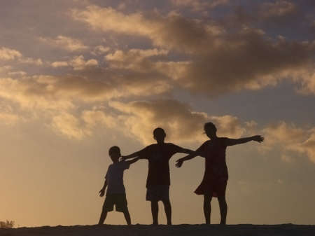 Fun in family playing on the sand of the beachの写真素材