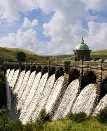 Water overflowing a dam, Craig Goch reservoir, Elan Valley Wales.の写真素材