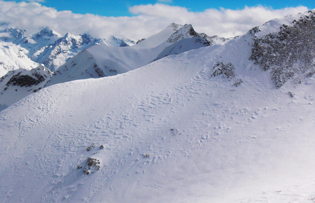 Views of snow capped mountains of Dombay. Winter Sunny day, looming snow clouds, mountain range,...