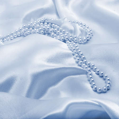 Pearls a necklace on a silk fabric の写真素材