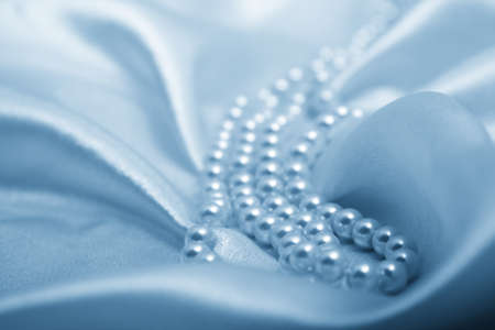 Pearls a necklace on a silk fabric の写真素材