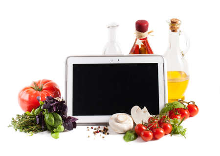 Tablet computer with vegetables on white backgroundの写真素材