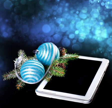 Tablet PC with Christmas decoration on blackの写真素材
