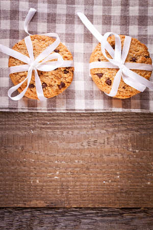 Stacked chocolate chip cookies on wooden tableの写真素材