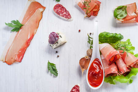 Sliced prosciutto in white wooden backgroundの写真素材