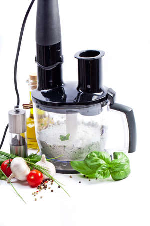Blender with fresh vegetables and herbsの写真素材