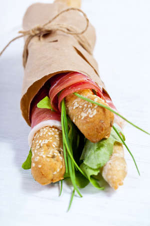 Parma ham prosciutto with grissini bread sticksの写真素材