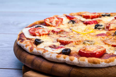 Delicious fresh pizza served on wooden tableの写真素材