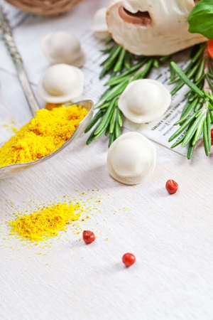 Tortellini and vegetables on white wooden backgroundの写真素材