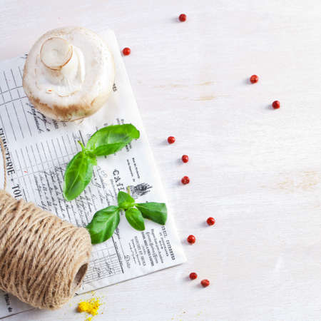 Fresh mushrooms and herbs on an old wooden board.の写真素材