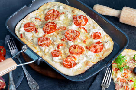 Delicious fresh pizza on darkの写真素材