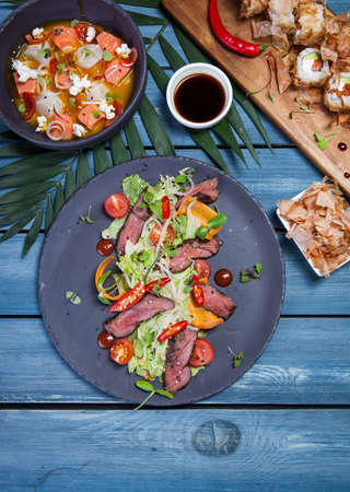Japanese salad with meat, chili pepper, cherry tomatoes and fresh sproutsの写真素材