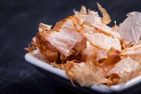 Ingredients for sushi on black plate in dark wooden backgroundの写真素材