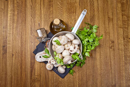 Fresh champignon mushrooms on wooden tableの写真素材