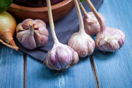 Fresh healthy eggplants on dark wooden background.